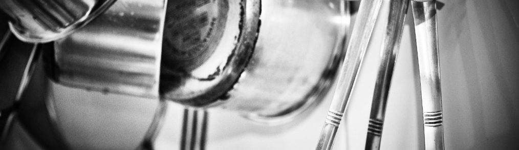 Stainless steel pots and utensils hanging from ceiling