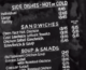 close up of a menu board showing prices for sandwiches and soups