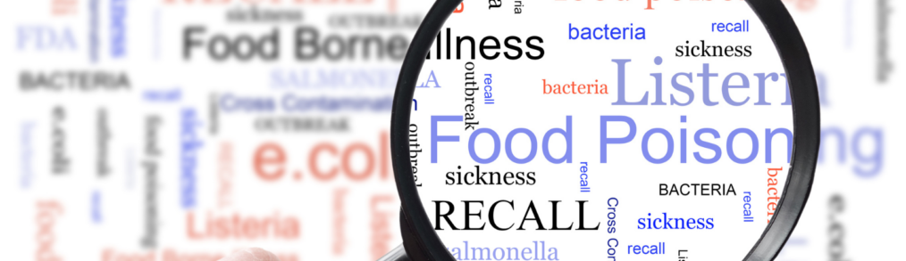 food safety related words blurred out with words in focus under a magnifying glass