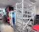 Alto-Hartley commercial kitchen equipment showroom in Alexandria, Virginia, featuring stainless steel bakery racks, convection ovens, prep tables, transport carts, and storage equipment used in restaurant and foodservice operations.