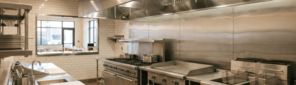 inside a commercial kitchen looking out the passthrough window toward the dining room
