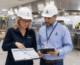 Consultant and facilities lead reviewing a phased schedule during a large scale kitchen installation